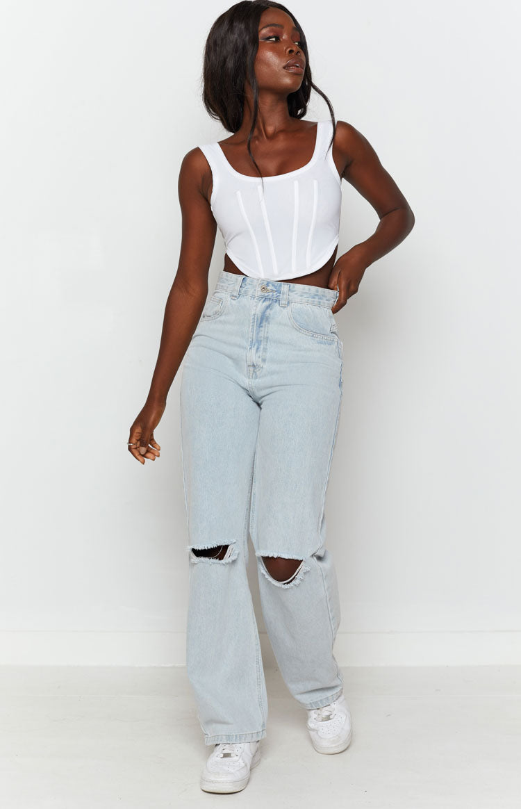 High-waisted light blue wide leg jeans with distressed ripped knees