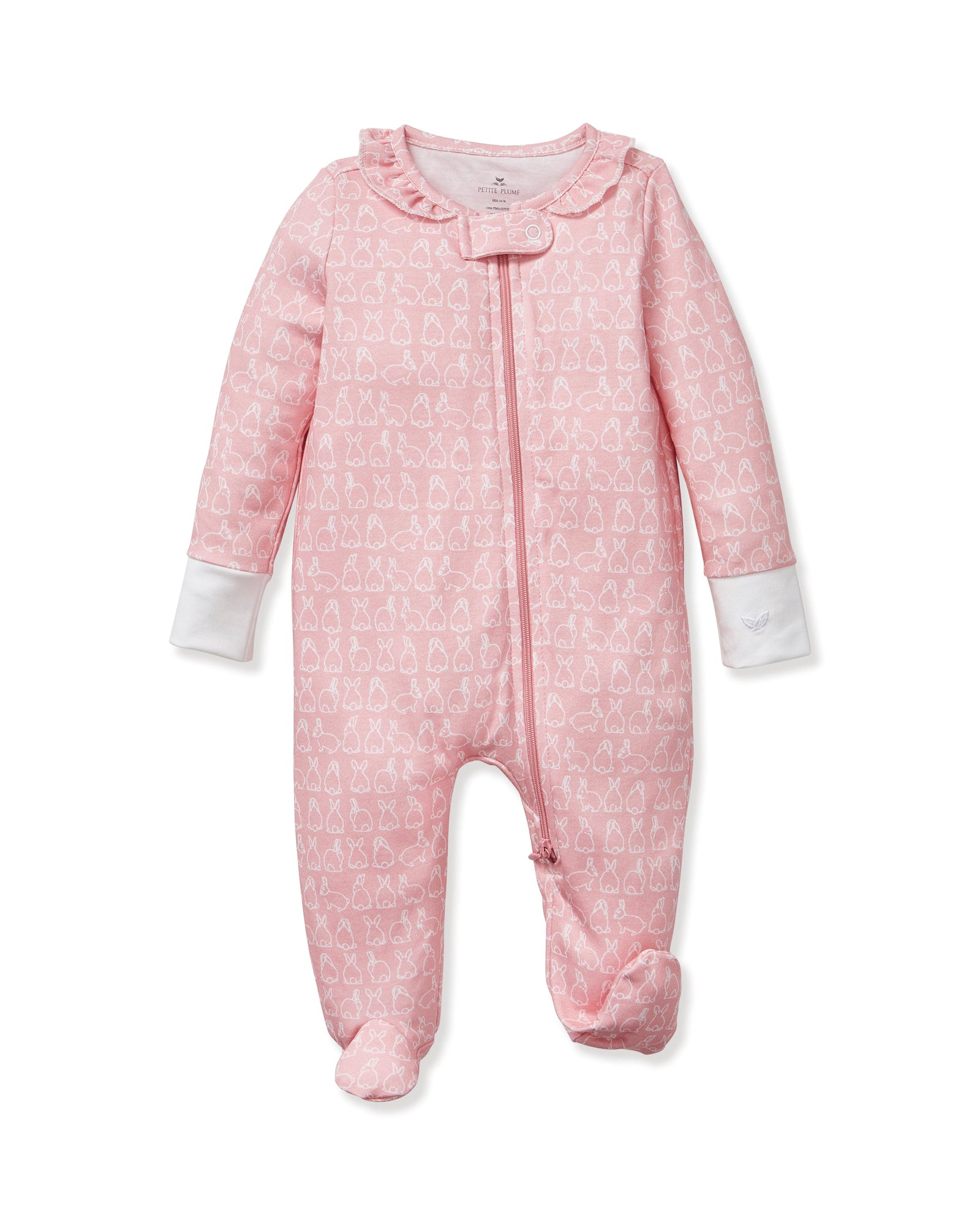 The Baby's Pima Romper in Hoppy Days Pink features long sleeves, white cuffs, a front zipper, a soft white bunny pattern, and a ruffled neckline.