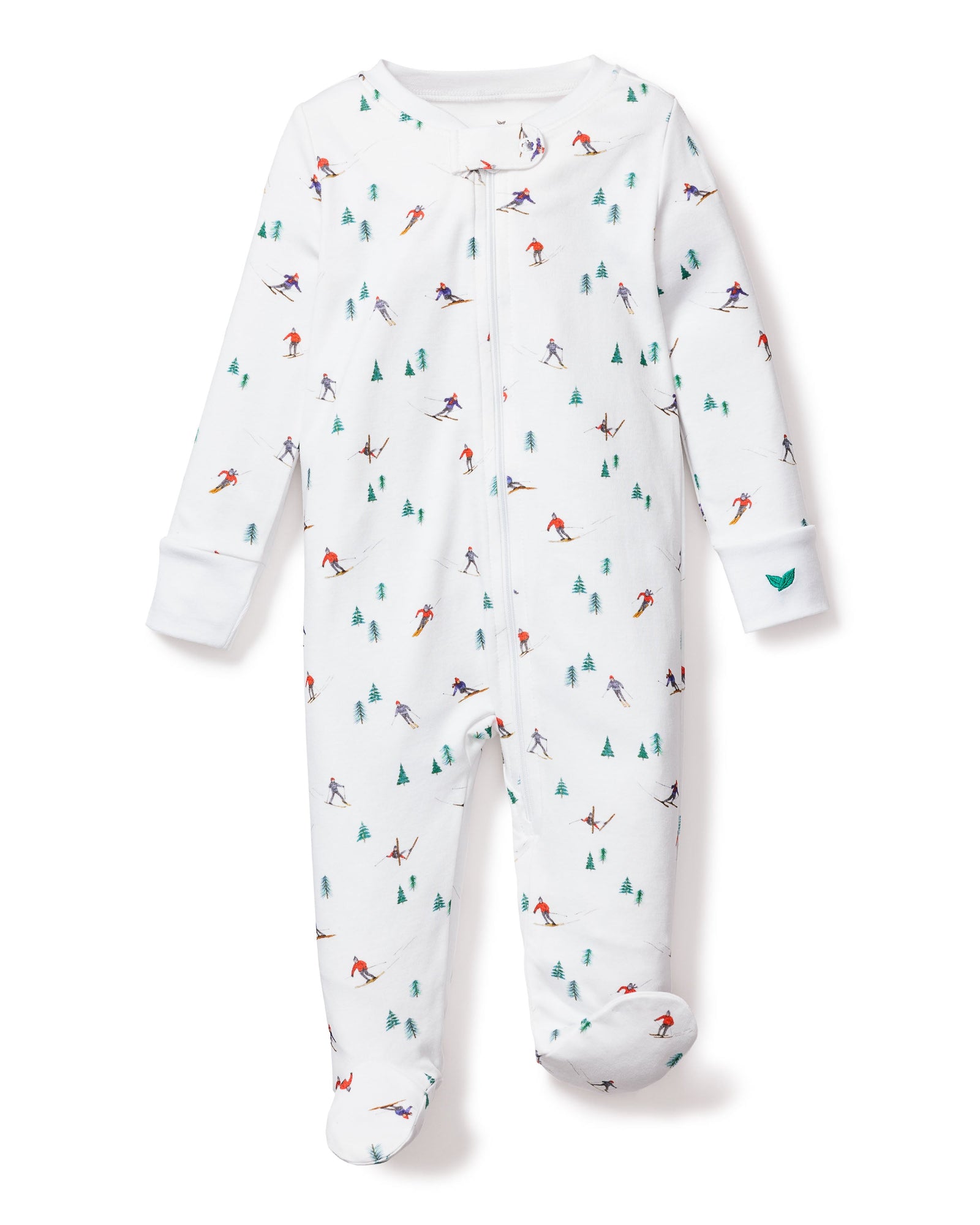 The Petite Plume Babys Pima Romper in Apres Ski is a white onesie crafted from soft Pima cotton, featuring a zip-up front, long sleeves, enclosed feet, and charming skier and evergreen tree patterns in green, blue, red, and purple for extra warmth.