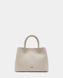 The CATIRA S - 8325006 Vanilla by Rudsak is a beige womens pebble leather tote with two rounded handles, subtle stitching, a removable shoulder strap, and the brand name near the bottom, shown upright on a plain light background.