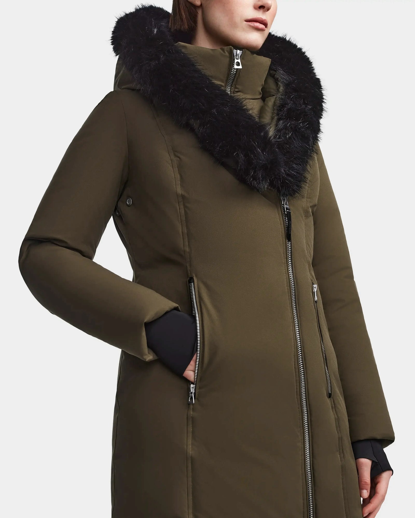 A person wearing the Rudsak MAIA M - 8123582 Army winter jacket in olive green, featuring a black faux fur-lined hood and silver zippers, is shown from shoulders to mid-thigh against a plain background.