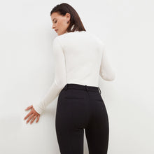 Back image of a woman standing wearing the Curie Pant--Worth in Black