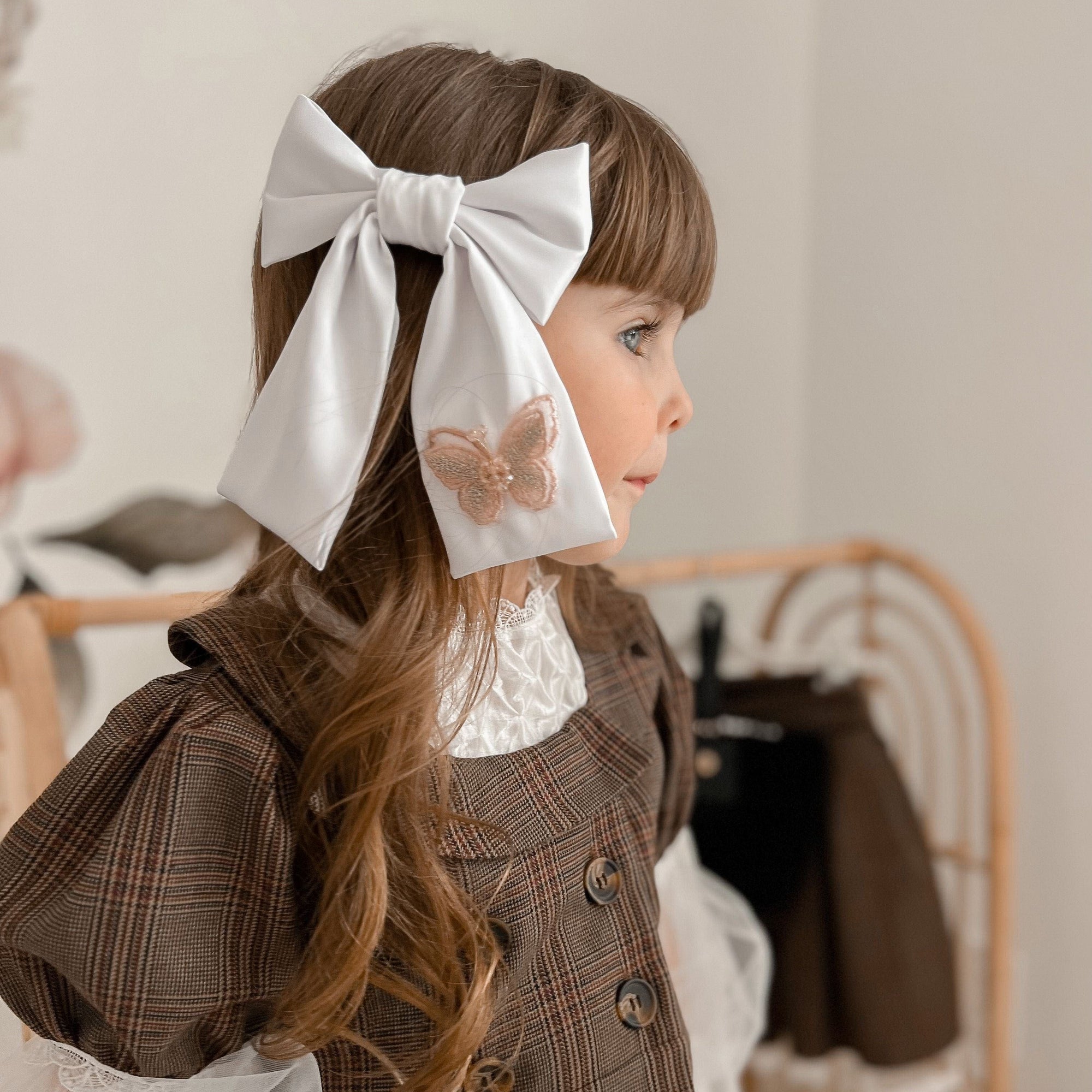girl with large satin clip on bow with butterfly embellishment