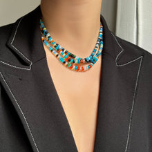A model wears a blazer and a triple strand of Jaipur Jazz faceted opal necklaces around her neck.