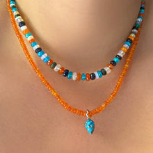 orange opal necklace with turquoise drop charm layered with jaipur jazz faceted opal necklace on the body.