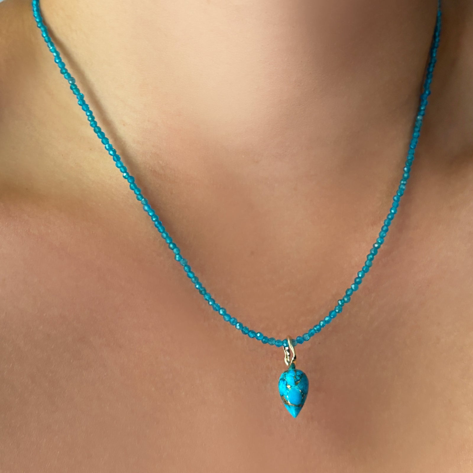 turquoise drop charm on blue apatite slim gemstone necklace on the neck