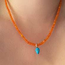 turquoise drop charm on orange opal necklace on the neck
