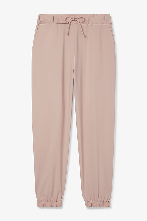 Front image of a woman wearing the Delaney jogger in Blush | Still | Exclude