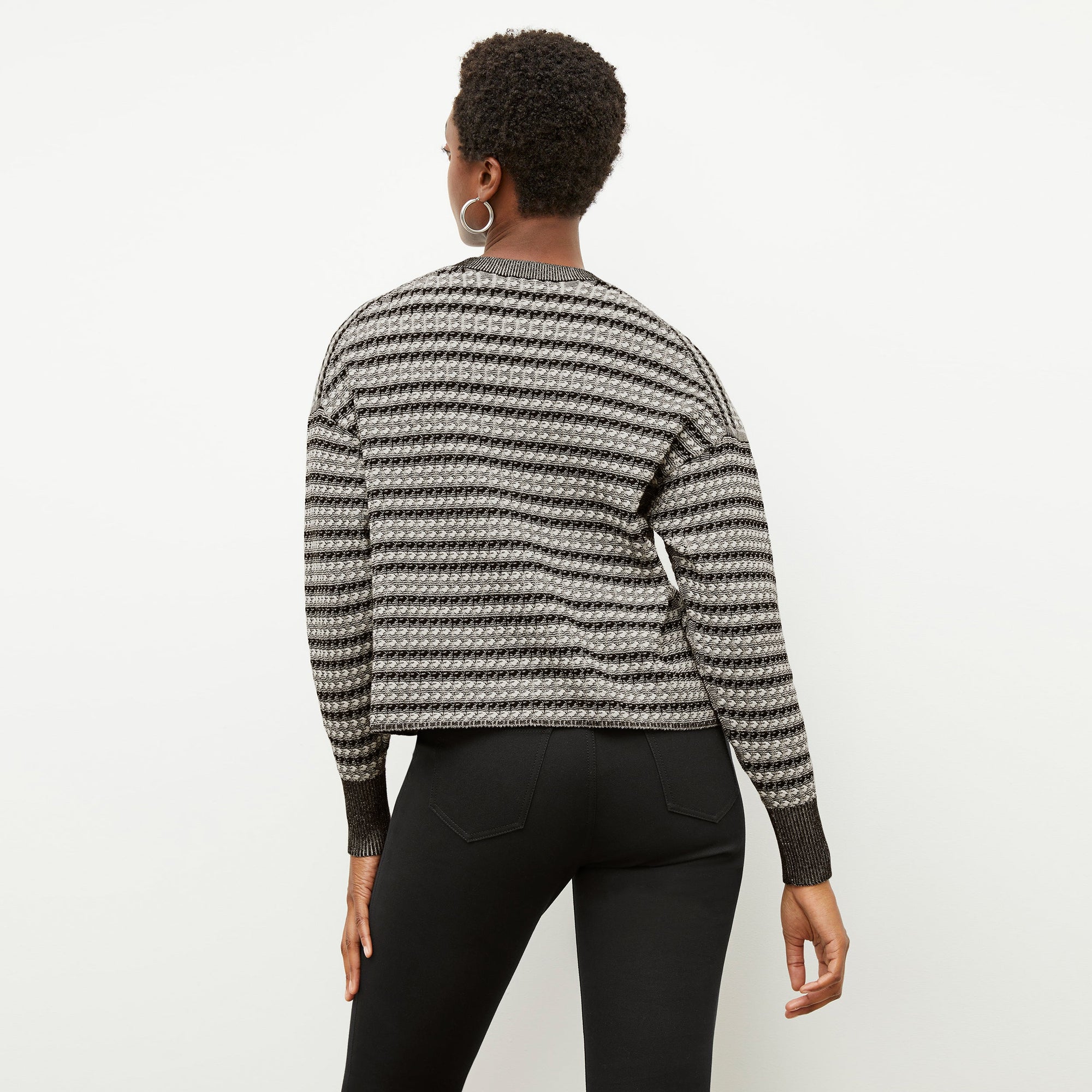 Back image of a woman wearing the tyler sweatshirt in black and white