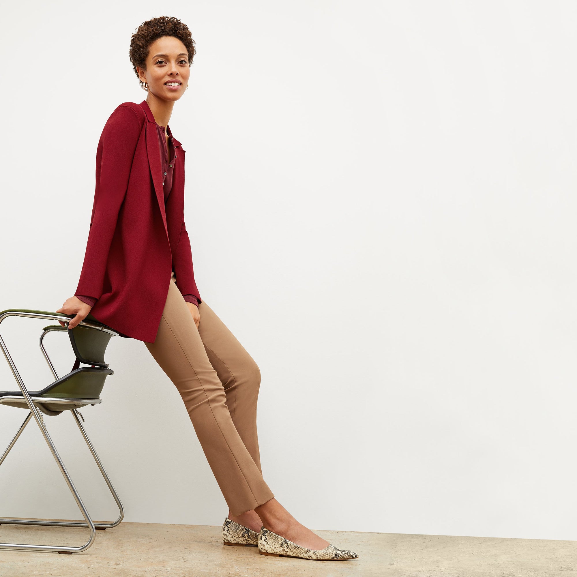 Front image of a woman sitting wearing the Foster Pant—Everstretch in Saddle