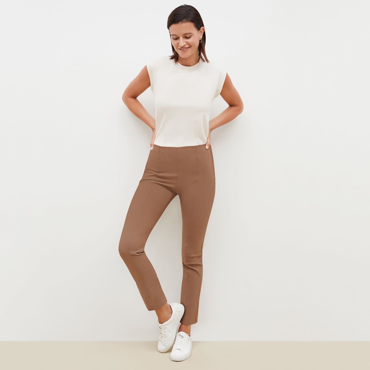Front image of a woman standing wearing the Foster Pant—Everstretch in Saddle | Exclude